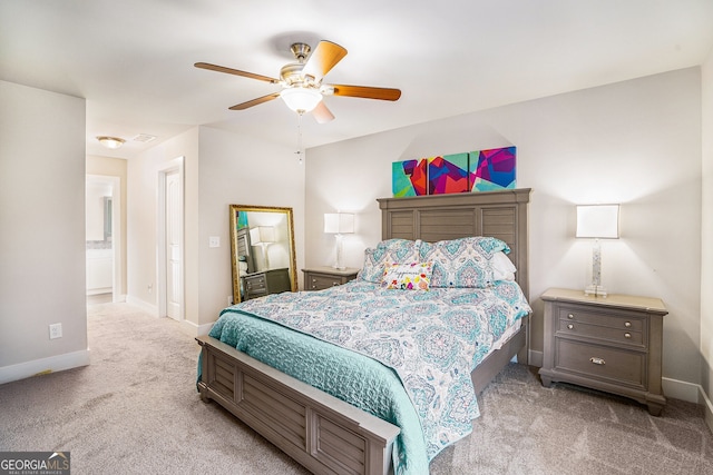 carpeted bedroom with a ceiling fan and baseboards