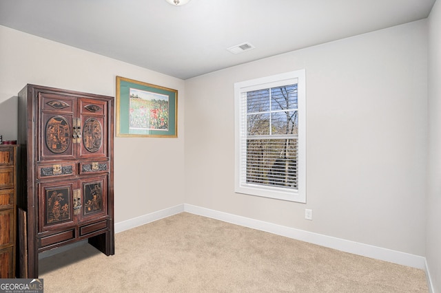 empty room with light carpet, baseboards, and visible vents