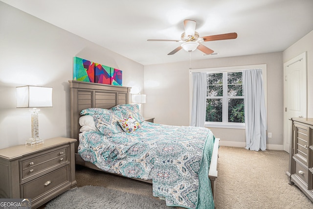 bedroom with light carpet, baseboards, visible vents, and ceiling fan