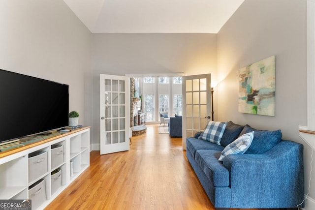 living room with french doors and light wood-style floors