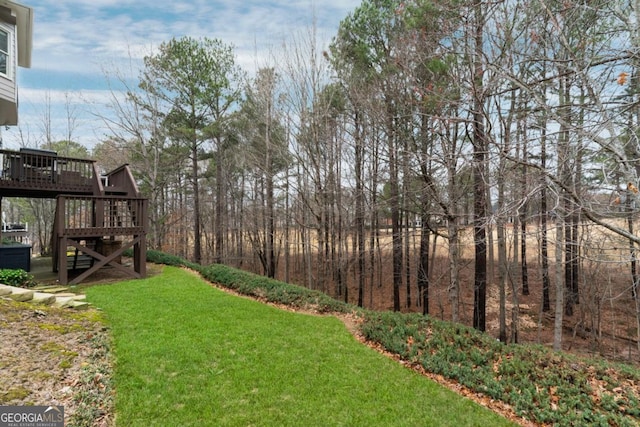 view of yard with stairway and a wooden deck