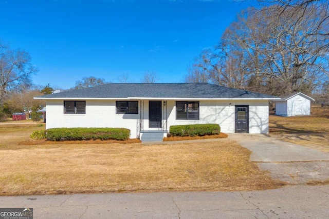 ranch-style house with a front lawn and an outbuilding