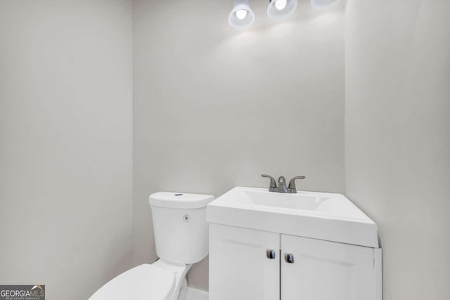 half bath with vanity and toilet