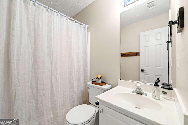 bathroom featuring a textured ceiling, toilet, vanity, visible vents, and a shower with curtain