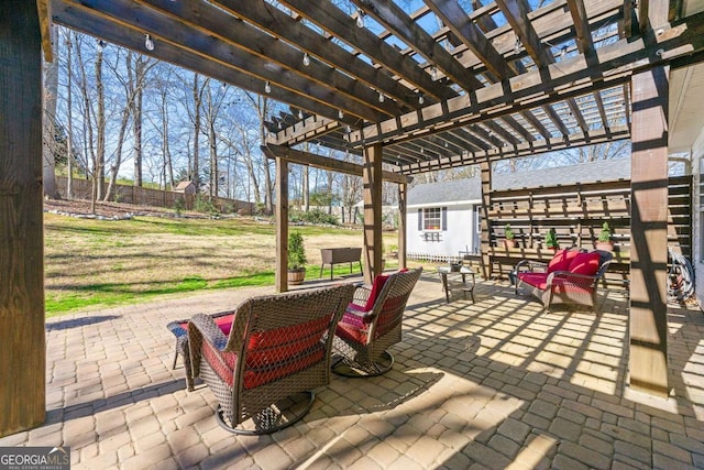 view of patio featuring fence and a pergola