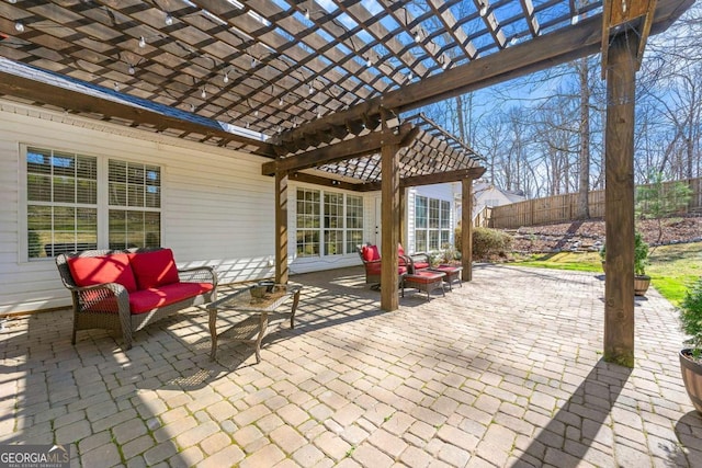 view of patio / terrace with an outdoor living space with a fire pit, fence, and a pergola