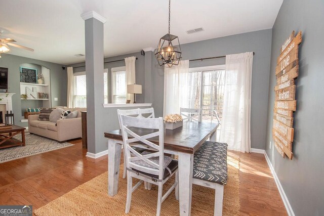 dining room with baseboards, a healthy amount of sunlight, visible vents, and light wood-style floors