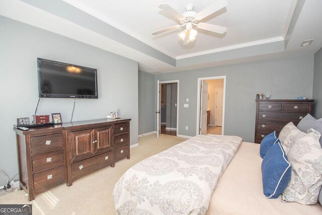 carpeted bedroom featuring ceiling fan, visible vents, baseboards, and a raised ceiling