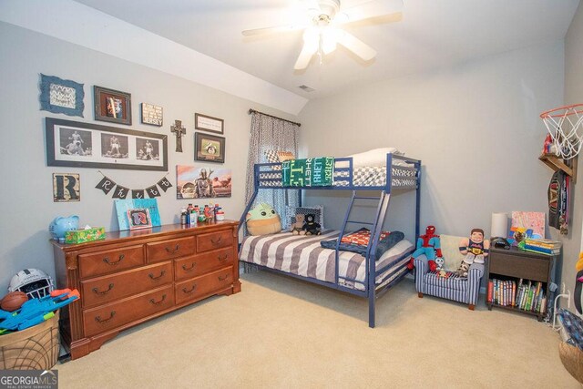 carpeted bedroom featuring lofted ceiling and ceiling fan