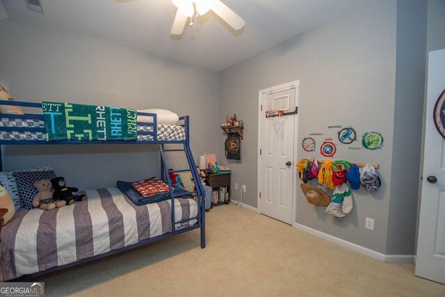 carpeted bedroom featuring visible vents, a ceiling fan, and baseboards