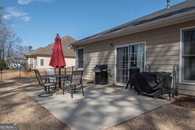 view of patio / terrace with outdoor dining space, fence, and area for grilling