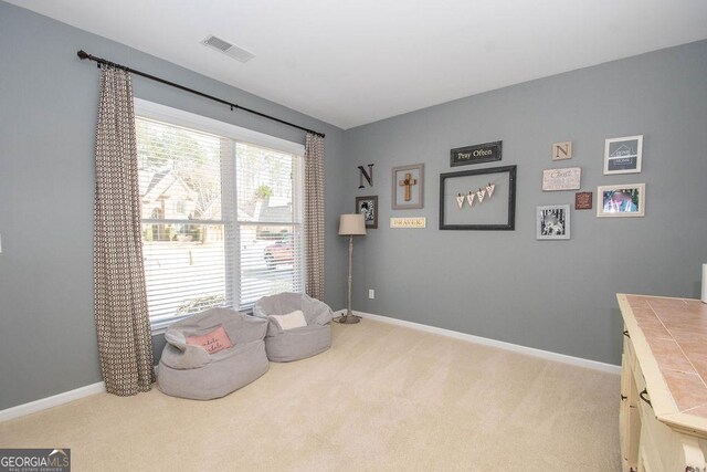 sitting room featuring carpet, visible vents, and baseboards