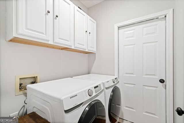 laundry room with cabinet space and separate washer and dryer