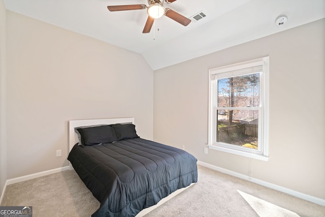 bedroom featuring vaulted ceiling, baseboards, visible vents, and carpet floors