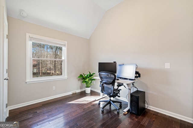 office space featuring baseboards, wood-type flooring, and vaulted ceiling