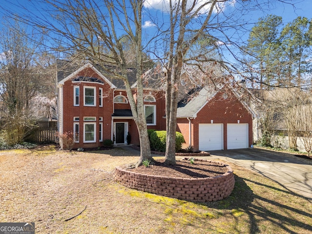 traditional home with a front yard, fence, driveway, an attached garage, and brick siding