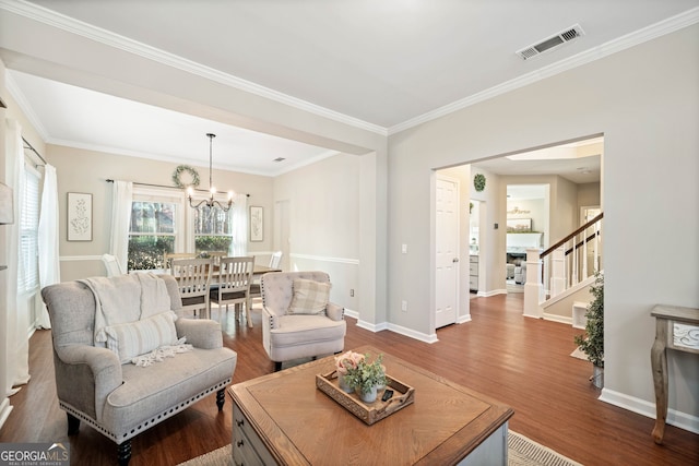 living room featuring baseboards, visible vents, dark wood finished floors, ornamental molding, and stairs