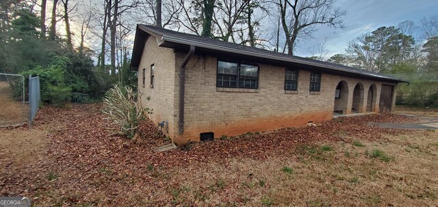 view of side of property with brick siding