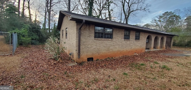 view of home's exterior featuring crawl space and brick siding