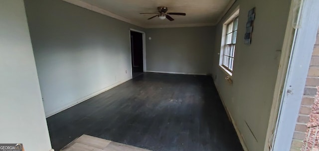 unfurnished room featuring baseboards, ceiling fan, ornamental molding, and wood finished floors