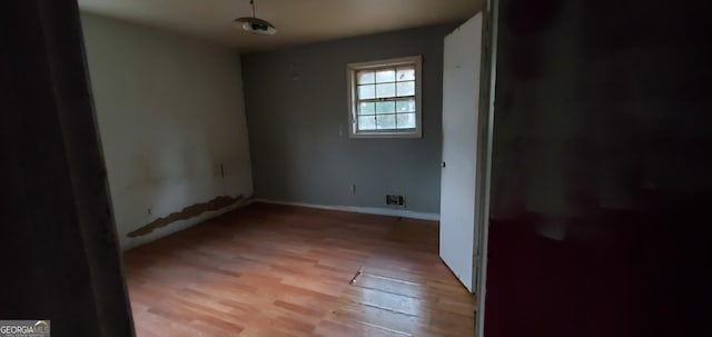 unfurnished room with visible vents and light wood-style floors