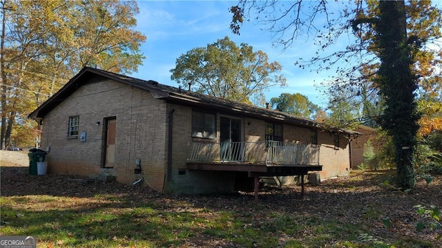 back of property featuring brick siding