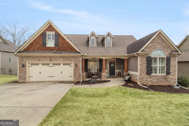 craftsman-style house featuring concrete driveway, covered porch, a front lawn, and roof with shingles