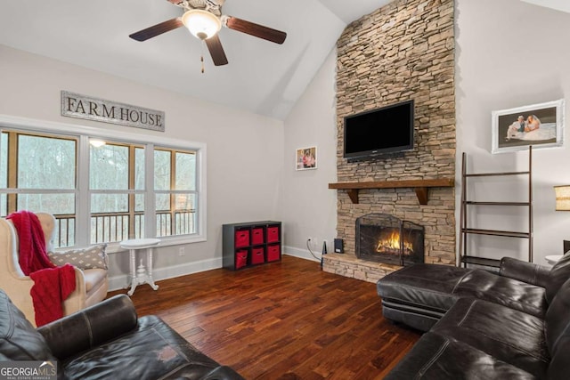 living room with ceiling fan, high vaulted ceiling, a stone fireplace, baseboards, and wood-type flooring