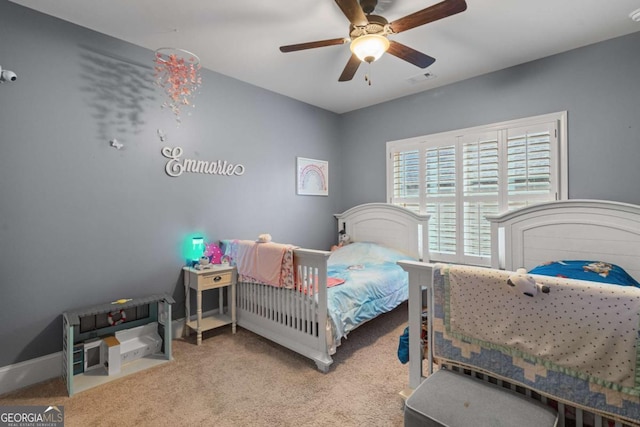 bedroom with carpet floors, visible vents, baseboards, and a ceiling fan