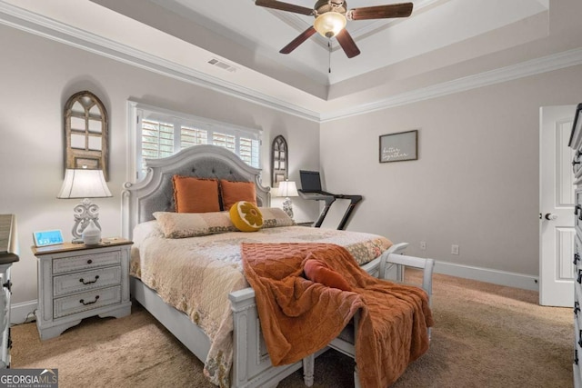 bedroom with light carpet, visible vents, baseboards, ornamental molding, and a raised ceiling