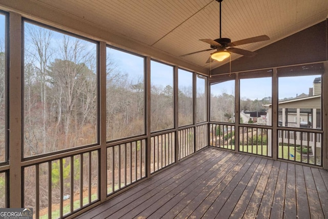 unfurnished sunroom featuring wood ceiling, ceiling fan, and vaulted ceiling