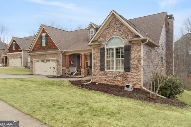 view of front facade with a garage, stone siding, a front yard, and driveway