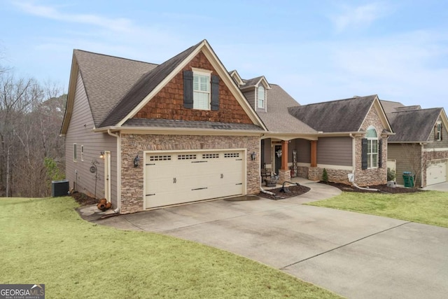 view of front facade with central air condition unit, a garage, a shingled roof, driveway, and a front lawn