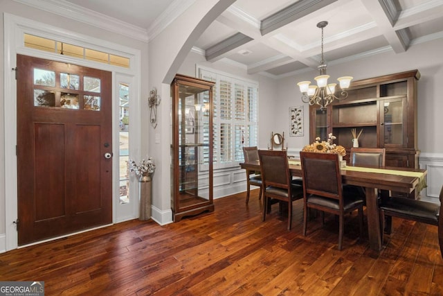 foyer featuring plenty of natural light, arched walkways, beamed ceiling, and hardwood / wood-style flooring