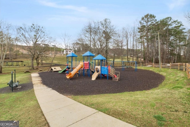 communal playground featuring fence and a yard