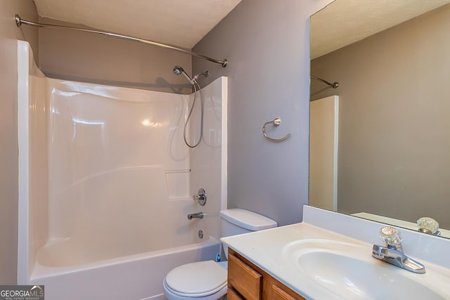 full bathroom with shower / washtub combination, vanity, toilet, and a textured ceiling