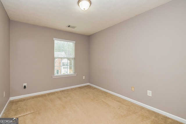 unfurnished room featuring light carpet, baseboards, and visible vents