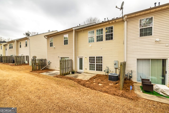 rear view of house featuring a patio, cooling unit, and fence