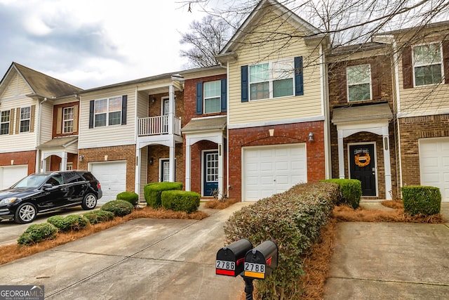 townhome / multi-family property with brick siding, driveway, and an attached garage