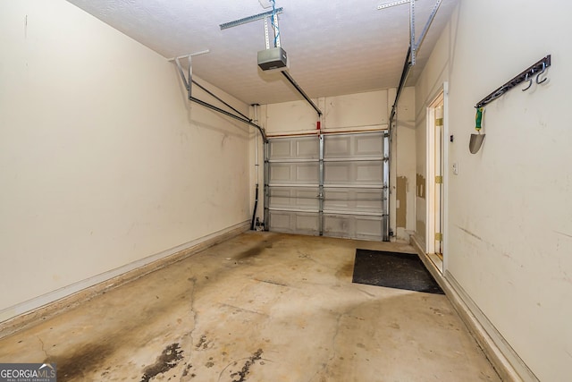 garage with a garage door opener and baseboards