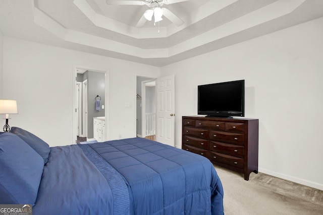 bedroom with carpet, a raised ceiling, ceiling fan, and baseboards