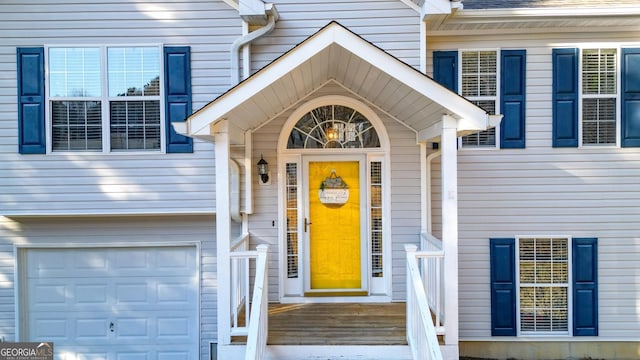 view of exterior entry featuring an attached garage