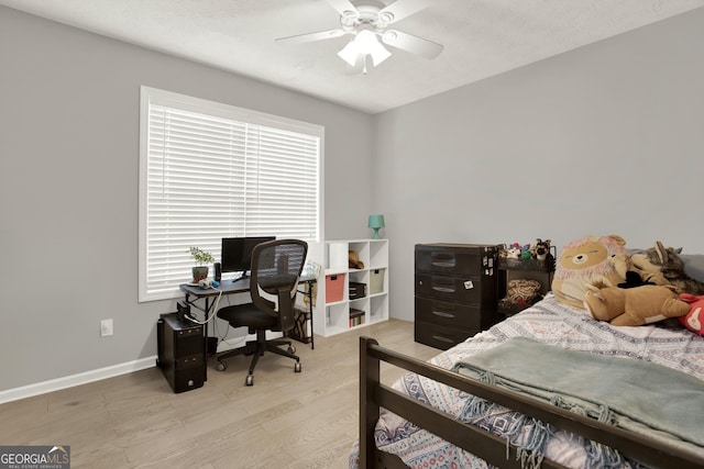 bedroom with light wood-type flooring, baseboards, and a ceiling fan