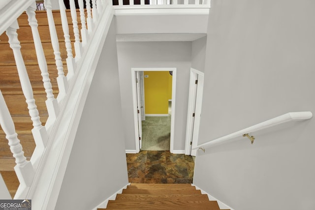 staircase with stone finish flooring and baseboards