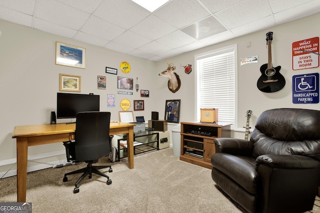 carpeted office with baseboards and a drop ceiling