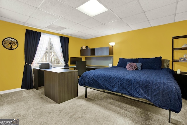 carpeted bedroom with a paneled ceiling