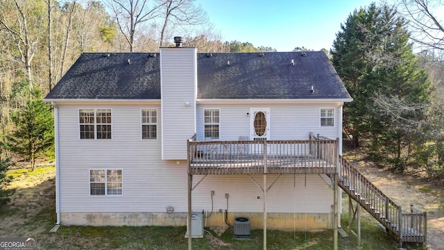 back of property with central air condition unit, stairs, a chimney, and a deck