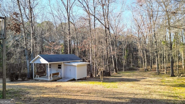 view of outdoor structure featuring a forest view and an outdoor structure