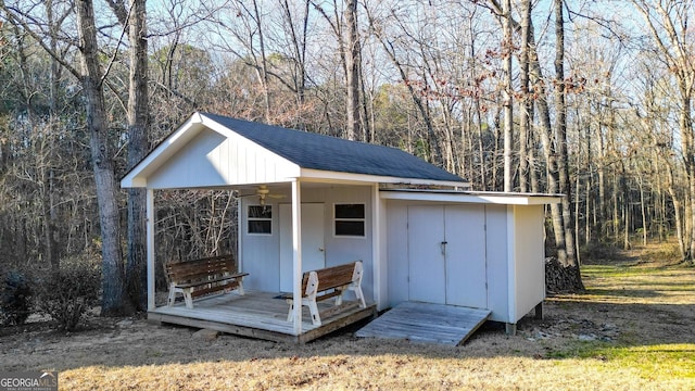 view of outdoor structure featuring an outbuilding and a wooded view