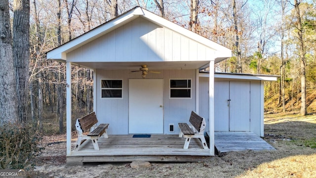 view of outdoor structure with an outbuilding and a forest view